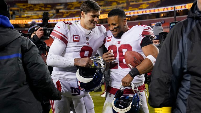 New York Giants quarterback Daniel Jones and running back Saquon Barkley walk off the field after a 20-12 victory over the Washington Commanders, Sunday, Dec. 18, 2022, in Landover, Md. (Susan Walsh/AP)