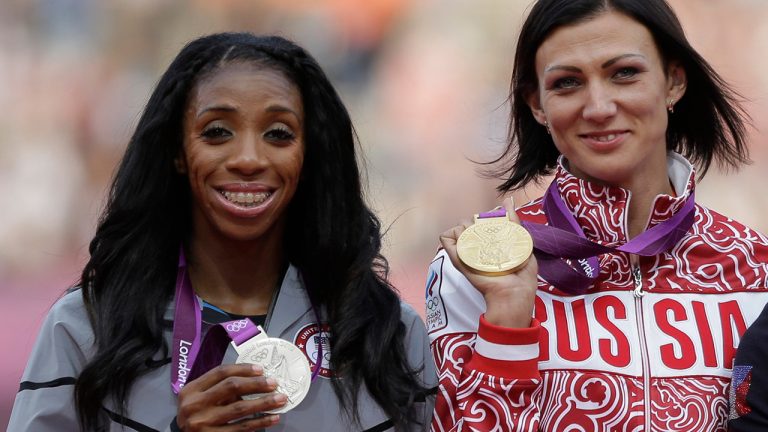 Russia's Natalya Antyukh holds the gold medal, United States' Lashinda Demus, left, the silver medal a during a ceremony for the women's 400-meter hurdles in the Olympic Stadium at the 2012 Summer Olympics, London, on Aug. 9, 2012. (Matt Slocum/AP)