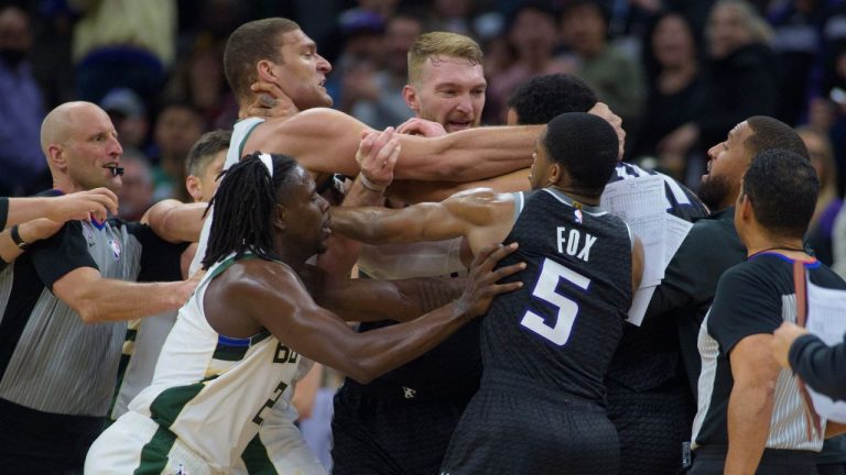 Milwaukee Bucks' Brook Lopez scuffles with Sacramento Kings forward Trey Lyles as members of both teams intervene in the final seconds of the second half of an NBA basketball game in Sacramento, Calif., Monday, March 13, 2023. (Randall Benton/AP Photo)
