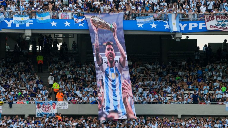 A banner of Lionel Messi holding the FIFA World Cup trophy hangs in the stands prior to an international friendly soccer match between Argentina and Panama in Buenos Aires, Argentina, Thursday, March 23, 2023. (Natacha Pisarenko/AP)