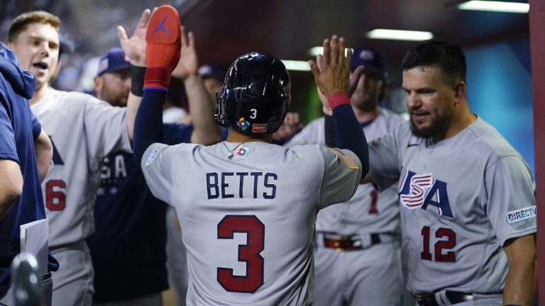 United States' Mookie Betts celebrates with teammates after scoring against Colombia on Mike Trout's single during the third inning of a World Baseball Classic game in Phoenix, Wednesday, March 15, 2023. (Godofredo A. Vásquez/AP)