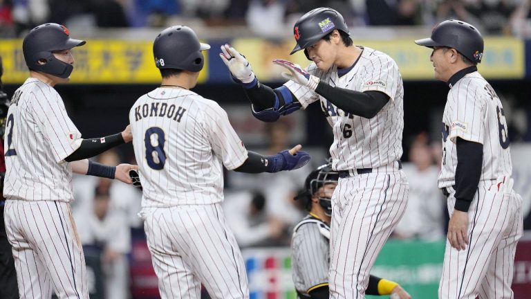 Japan's Shohei Ohtani, second right, celebrates with his teammates after hitting a three-run homer in the fifth inning of a World Baseball Classic exhibition match against Japanese club Hanshin Tigers. (Kyodo News via AP)