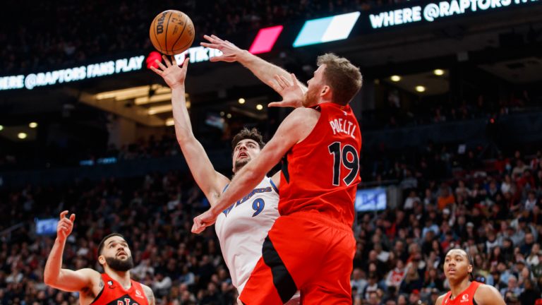 Washington Wizards forward Deni Avdija (9) is defended by at the net by Toronto Raptors centre Jakob Poeltl (19) during first half of their NBA game in Toronto on Sunday, Mar. 26, 2023. (Cole Burston/CP)