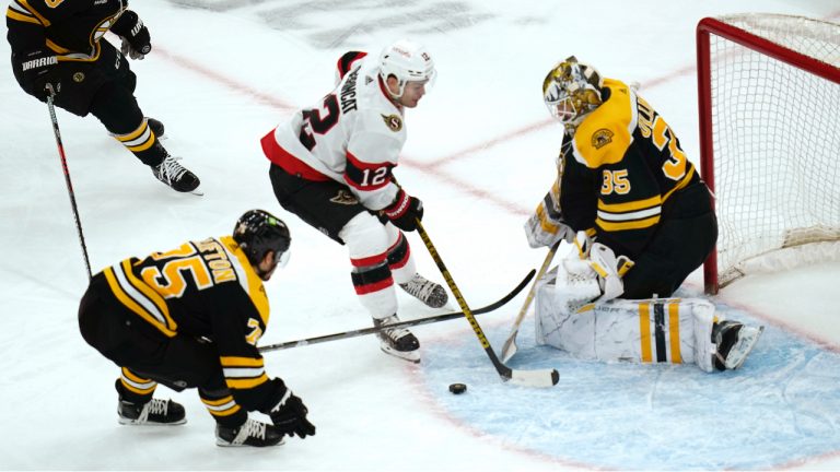Boston Bruins goaltender Linus Ullmark (35) makes a stick save on a shot by Ottawa Senators right wing Alex DeBrincat (12) during the second period of an NHL hockey game, Tuesday, March 21, 2023, in Boston. (AP)