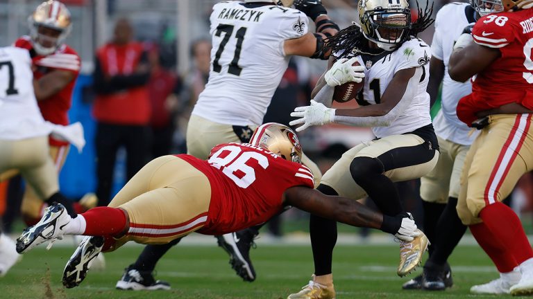 New Orleans Saints running back Alvin Kamara, right, runs against San Francisco 49ers defensive tackle T.Y. McGill (96) during the first half of an NFL football game in Santa Clara, Calif., Sunday, Nov. 27, 2022. (Jed Jacobsohn/AP)
