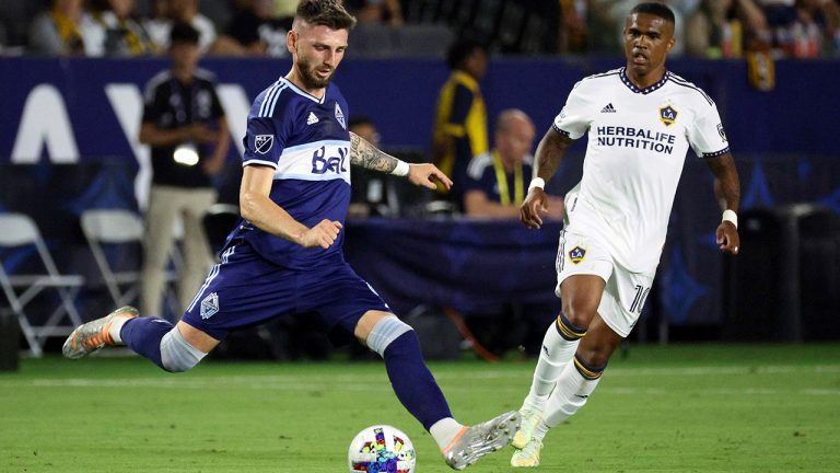 Vancouver Whitecaps defender Tristan Blackmon, left, moves the ball past LA Galaxy forward Douglas Costa during the second half of an MLS soccer match Saturday, Aug. 13, 2022, in Carson, Calif. (Raul Romero Jr./AP)