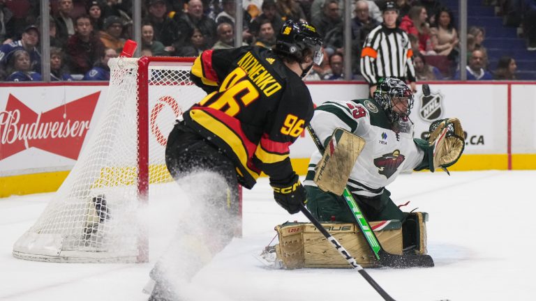 A shot goes wide of the net behind Minnesota Wild goalie Marc-Andre Fleury (29) as Vancouver Canucks' Andrei Kuzmenko 996) watches during the first period of an NHL hockey game in Vancouver, on Thursday, March 2, 2023. (Darryl Dyck/CP)