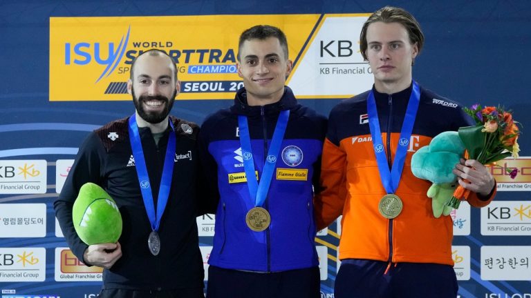 Gold medalist Pietro Sighel of Italy, center, poses with silver medalist Steven Dubois of Canada, left, and bronze medalist Jens van 'T wout, right, of the Netherlands during the award ceremony of the men's 500 meter at at the ISU World Short Track Speed Skating Championships in Seoul, South Korea, Saturday, March 11, 2023. (Ahn Young-joon/AP)