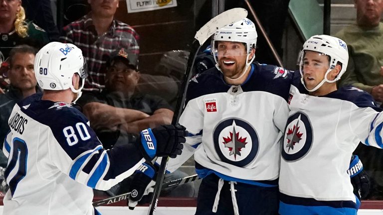 Winnipeg Jets right wing Blake Wheeler, middle, celebrates his game-winning goal against the Arizona Coyotes with Jets left wing Pierre-Luc Dubois (80) and Jets defenseman Neal Pionk, right, during overtime of an NHL hockey game at Mullett Arena. (Ross D. Franklin/AP)