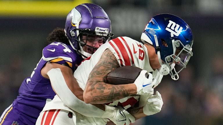 Minnesota Vikings' Eric Kendricks tackles New York Giants' Isaiah Hodgins during the second half of an NFL wild card football game Sunday, Jan. 15, 2023, in Minneapolis. (Abbie Parr/AP)