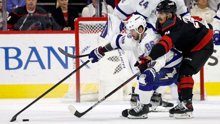 Carolina Hurricanes' Seth Jarvis (24) battles with Tampa Bay Lightning's Nikita Kucherov (86) during the first period of an NHL hockey game in Raleigh, N.C., Sunday, March 5, 2023. (Karl B DeBlaker/AP)