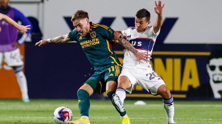 LA Galaxy forward Tyler Boyd, left, and Vancouver Whitecaps midfielder Andrés Cubas vie for the ball during the first half of an MLS soccer match in Carson, Calif., Saturday, March 18, 2023. (Ringo H.W. Chiu/AP Photo)