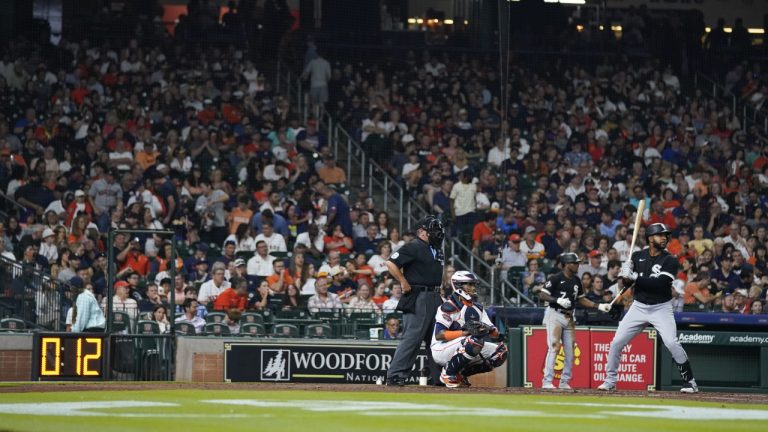 Chicago White Sox's Elvis Andrus, right, bats during the third inning of the team's baseball game against the Houston Astros, Friday, March 31, 2023, in Houston. The pitch clock is at left. (Eric Christian Smith/AP)