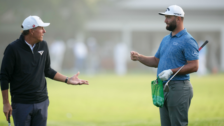 Phil Mickelson and Jon Rahm, of Spain, talk on the rage before a practice round for the Masters golf tournament at Augusta National Golf Club on Wednesday, April 5, 2023, in Augusta, Ga. (AP)