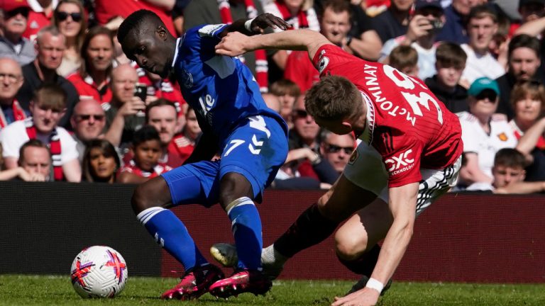 Manchester United's Scott McTominay, right, challenges for the ball with Everton's Idrissa Gueye during the English Premier League soccer match between Manchester United and Everton, at the Old Trafford stadium in Manchester, England, Saturday, April 8, 2023. (Dave Thompson/AP) 
