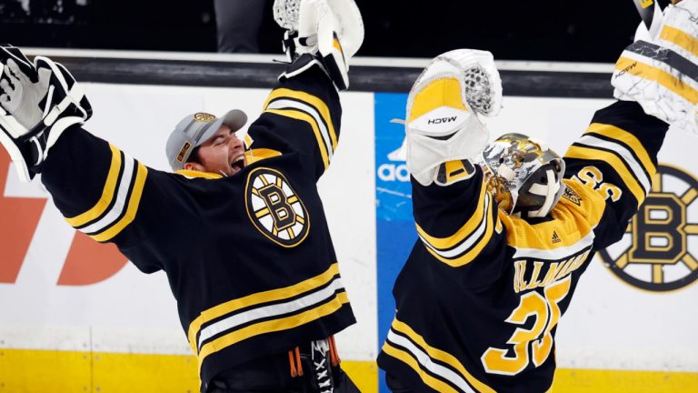 Boston Bruins' Linus Ullmark (35) and Jeremy Swayman celebrate the team's win over the New Jersey Devils in an NHL hockey game, Saturday, April 8, 2023, in Boston. (AP Photo/Michael Dwyer)