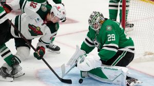 Minnesota Wild left wing Matt Boldy (12) attempts to get a shot past Dallas Stars goaltender Jake Oettinger (29) in the third period of Game 2 of an NHL hockey Stanley Cup first-round playoff series, Wednesday, April 19, 2023, in Dallas. (AP Photo/Tony Gutierrez) 