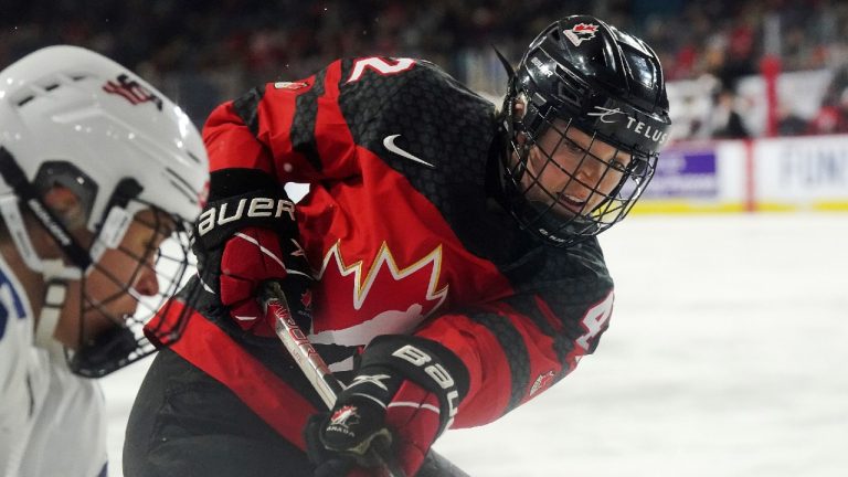 Canada's Claire Thompson (42) battles along the boards against the United States during first period Rivalry Series hockey action in Kamloops, B.C., Thursday, Nov. 17, 2022. (Jesse Johnston/CP)