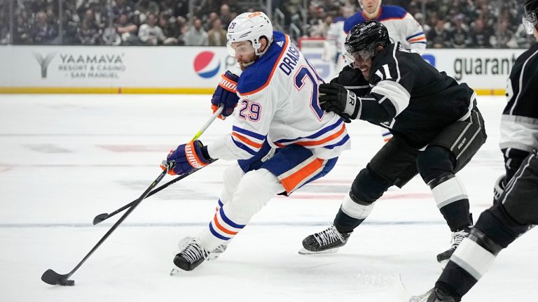 Edmonton Oilers center Leon Draisaitl, left, moves the puck while under pressure from Los Angeles Kings center Anze Kopitar during the first period in Game 3 of an NHL hockey Stanley Cup first-round playoff series Friday, April 21, 2023, in Los Angeles. (Mark J. Terrill/AP)