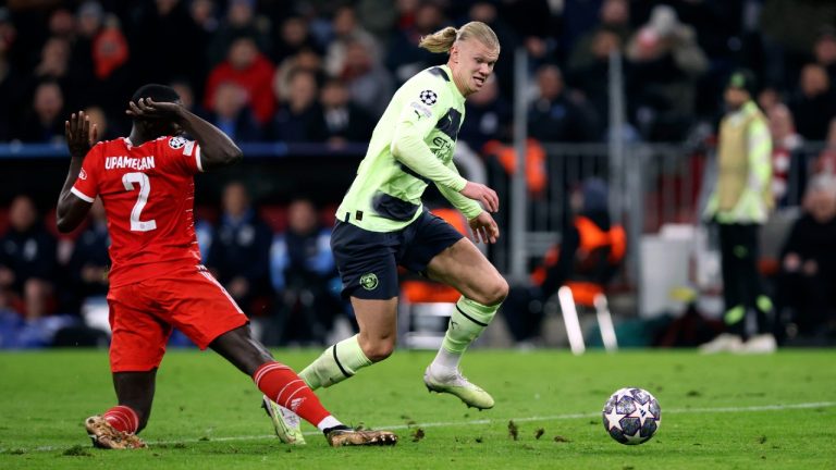 Manchester City's Erling Haaland, right, dribbles past Bayern Munich's Dayot Upamecano, left, to score to 0-1 during the Champions League quarter final second leg soccer match between Bayern Munich and Manchester City, at the Allianz Arena stadium in Munich, Germany, Wednesday, April 19, 2023. (Matthias Balk/dpa via AP)