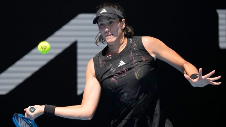 Garbine Muguruza of Spain plays a forehand return to Elise Mertens of Belgium during their first round match at the Australian Open tennis championship in Melbourne, Australia, Tuesday, Jan. 17, 2023. (AP Photo/Dita Alangkara)