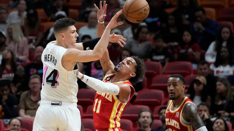 Miami Heat guard Tyler Herro (14) passes past Atlanta Hawks guard Trae Young (11) during the first half of an NBA basketball game, Monday, March 6, 2023, in Miami. (Wilfredo Lee/AP)