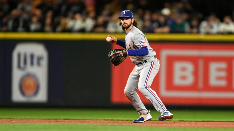 Texas Rangers third baseman Josh Smith prepares to throw to first baseman Nathaniel Lowe for the out on Seattle Mariners' Sam Haggerty during the sixth inning of a baseball game Wednesday, Sept. 28, 2022, in Seattle. (Caean Couto/AP)