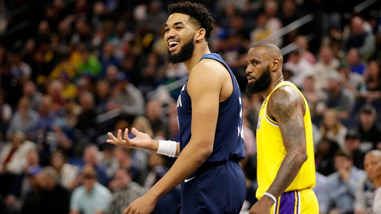 Minnesota Timberwolves center Karl-Anthony Towns argues after being called for charging as Los Angeles Lakers forward LeBron James, right, defended during the first half of an NBA basketball game Wednesday, March 16, 2022, in Minneapolis. (Andy Clayton-King/AP)