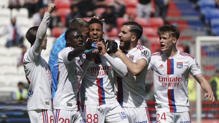 Lyon's Corentin Tolisso, center, is congratulated after scoring his side's opening goal during the French League One soccer match between Lyon and Rennes at the Groupama stadium, in Decines, near Lyon, France, Sunday, April 9, 2023. (Laurent Cipriani/AP)
