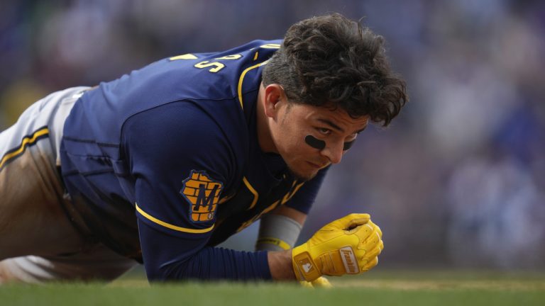 Milwaukee Brewers second baseman Luis Urias gets up after being tagged out at first during the ninth inning of a baseball game against the Chicago Cubs Thursday, March 30, 2023, in Chicago. The Cubs won 4-0. (Erin Hooley/AP)