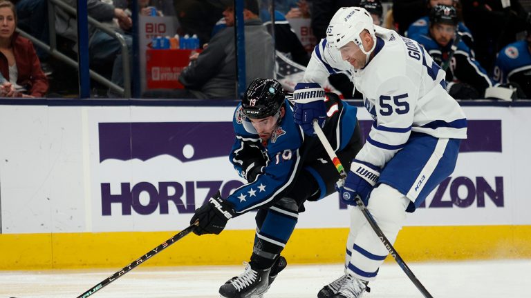 Columbus Blue Jackets forward Liam Foudy, left, reaches for the puck next to Toronto Maple Leafs defenseman Mark Giordano during the second period of an NHL hockey game in Columbus, Ohio, Friday, Feb. 10, 2023. (Paul Vernon/AP)