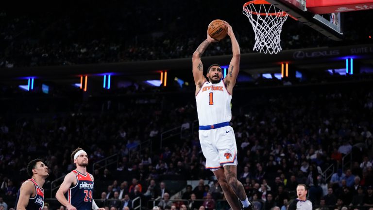 New York Knicks' Obi Toppin (1) dunks the ball in front of Washington Wizards' Corey Kispert (24) and Johnny Davis (1) during the first half of an NBA basketball game Sunday, April 2, 2023, in New York. (Frank Franklin II/AP)