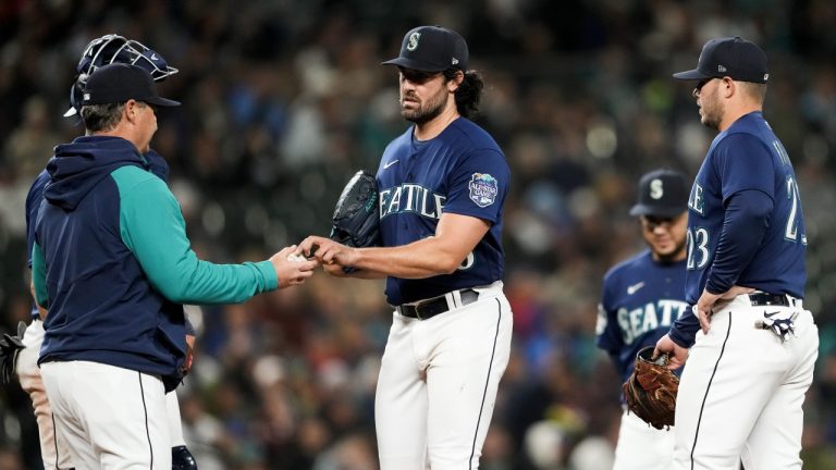 Seattle Mariners starting pitcher Robbie Ray (38) gives the ball to manager Scott Servais as he is taken out of the baseball game against the Cleveland Guardians during the fourth inning Friday, March 31, 2023, in Seattle. (Lindsey Wasson/AP)