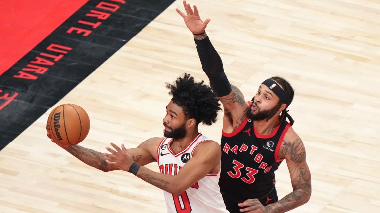 Chicago Bulls guard Coby White (0) drives past Toronto Raptors guard Gary Trent Jr. (33) during first half NBA basketball action in Toronto on Wednesday, April 12, 2023. (Nathan Denette/CP)
