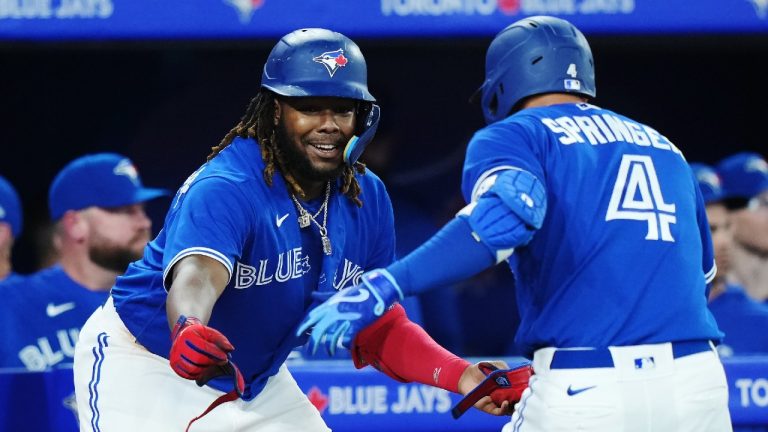 Toronto Blue Jays right fielder George Springer (4) celebrates his solo home run against the Detroit Tigers with teammate Vladimir Guerrero Jr. (27) during fifth inning MLB American League baseball action in Toronto on Tuesday, April 11, 2023. (Nathan Denette/CP)