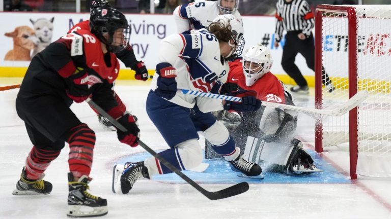 Japan goaltender Miyuu Masuhara (20) makes save against USA forward Alex Carpenter (25) as Japan defender Shiori Koike (2) keeps close during first period IIHF Women’s World Hockey Championship hockey action in Brampton, Ont., on Wednesday, April 5, 2023. (Nathan Denette/CP)