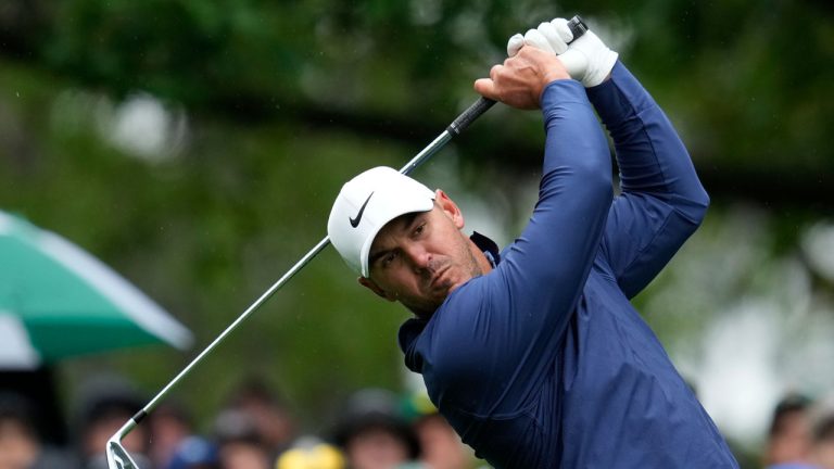 Brooks Koepka watches his tee shot on the fourth hole during the weather delayed third round of the Masters golf tournament at Augusta National Golf Club. (Mark Baker/AP)