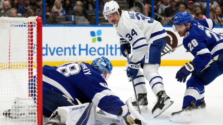 Tampa Bay Lightning goaltender Andrei Vasilevskiy (88) makes a save on a shot by Toronto Maple Leafs center Auston Matthews (34) during the first period of an NHL hockey game Saturday, Dec. 3, 2022, in Tampa, Fla. Defending for the Lightning is Ian Cole (28). (Chris O'Meara/AP)