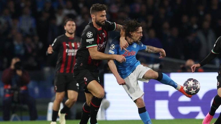 Milan's Olivier Giroud, left, and Napoli's Mario Rui fight for the ball during the Champions League quarterfinal second leg soccer match between Napoli and Milan, at Naples' Diego Armando Maradona stadium, in Napoli, Tuesday April 18, 2023. (Alessandro Garofalo/LaPresse via AP)