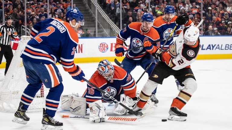 Anaheim Ducks' Isac Lundestrom (21) is stopped by Edmonton Oilers goalie Jack Campbell (36) as Evan Bouchard (2) and Connor McDavid (97) look for the rebound during first period NHL action in Edmonton on Saturday April 1, 2023. (CP Photo)