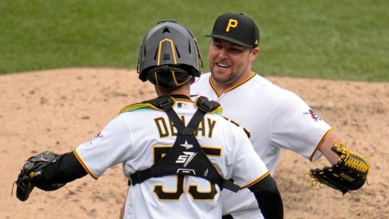 Pittsburgh Pirates relief pitcher David Bednar, right, celebrates with catcher Jason Delay after getting the final out of a win over the Cincinnati Reds in a baseball game in Pittsburgh, Sunday, April 23, 2023. (Gene J. Puskar/AP Photo)