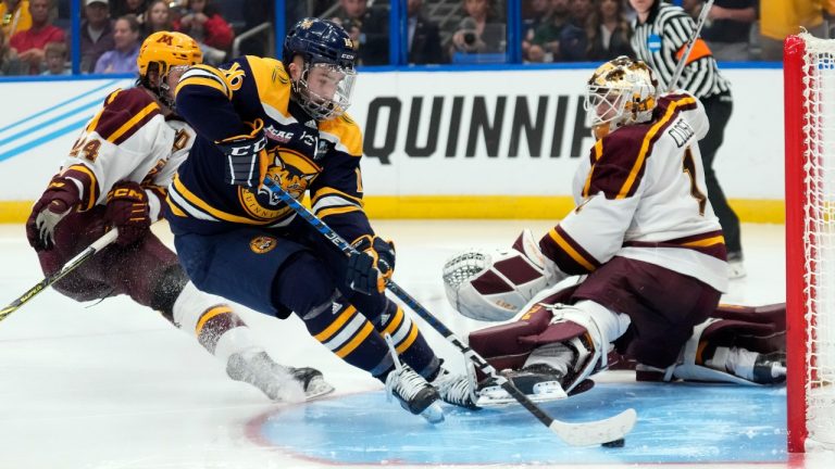 Quinnipiac forward Jacob Quillan (16) scores the game-winning goal past Minnesota goaltender Justen Close during overtime of the championship game in the Frozen Four NCAA college hockey tournament Saturday, April 8, 2023, in Tampa, Fla. (Chris O'Meara/AP)