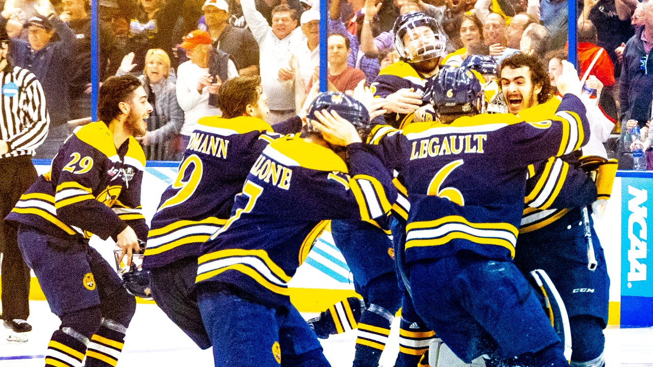 Players from the Quinnipiac men's hockey team celebrate after defeating Minnesota in overtime to win their first NCAA hockey title Saturday night in Tampa, Fla. (Photo Credit: Paul Barnick)