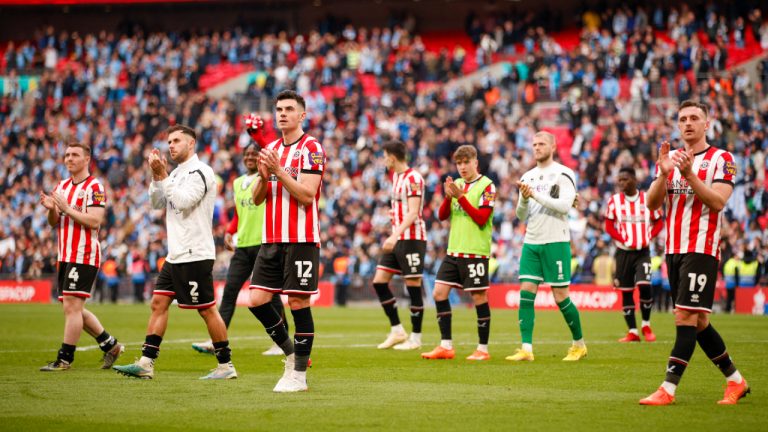 Sheffield United players greet fans at the end of the English FA Cup semi final soccer match between Manchester City and Sheffield United at Wembley stadium, in London, Saturday, April 22, 2023. (David Cliff/AP)