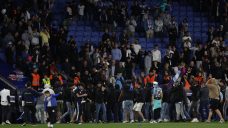 Early end to Barcelona’s title celebrations after Espanyol fans invade pitch