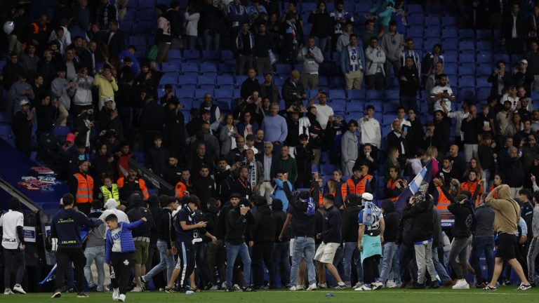 Supporters run in the file after the Spanish La Liga soccer match between Espanyol and Barcelona at the RCDE stadium in Barcelona, Sunday, May 14, 2023. (Joan Monfort/AP)