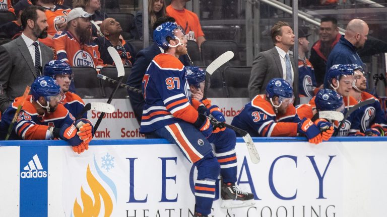 Edmonton Oilers' Connor McDavid (97) sits on the boards as the Vegas Golden Knights celebrate the win during NHL Stanley Cup second round playoff action in Edmonton on Sunday May 14, 2023. (Jason Franson/CP)
