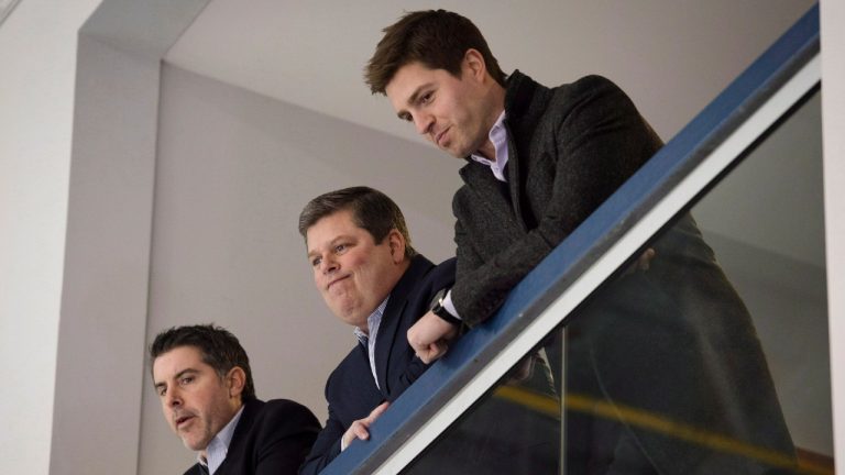 Dave Nonis, centre, senior vice-president and GM of the Toronto Maple Leafs, watches the team practice with Brandon Pridham, left, assistant to the GM, and Kyle Dubas, assistant GM, following the firing of head coach Randy Carlyle in Toronto on Tuesday, January 6, 2015. Darren Calabrese/THE CANADIAN PRESS