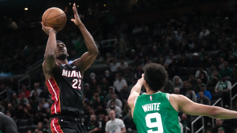 Miami Heat forward Jimmy Butler, left, shoots as Boston Celtics guard Derrick White defends during the second half in Game 5 of the NBA basketball Eastern Conference finals Thursday, May 25, 2023, in Boston. (AP Photo/Charles Krupa )