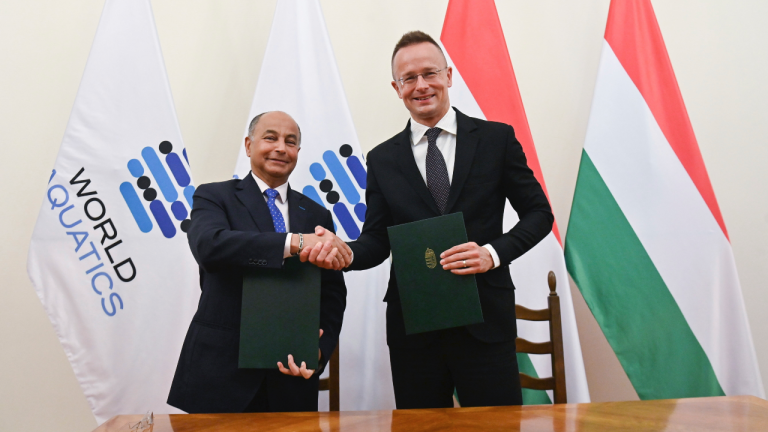 World Aquatics President Husain Al Musallam, left, and Minister of Foreign Affairs and Trade Peter Szijjarto shake hands upon signing a Strategic Memorandum of Understanding in Budapest, Hungary, Friday, May 26, 2023. The agreement facilitates the relocation of World Aquatics headquarters, an organisation formerly known as FINA, from Lausanne in Switzerland to Budapest. (Noemi Bruzak/MTI via AP)